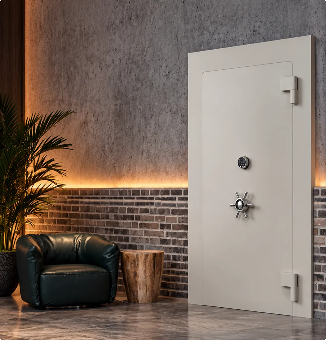 A safe door in a lit room with a grey stone wall